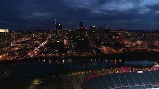 5.7K aerial stock footage approach the city's skyline and river from stadium at twilight, Downtown Nashville, Tennessee Aerial Stock Footage | DX0002_121_010