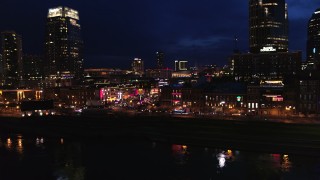 5.7K aerial stock footage orbit the end of Broadway with traffic at twilight, reveal Pinnacle skyscraper in Downtown Nashville, Tennessee Aerial Stock Footage | DX0002_121_021