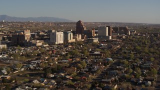 DX0002_122_006 - 5.7K aerial stock footage of approaching the city's high-rises from neighborhoods during ascent, Downtown Albuquerque, New Mexico