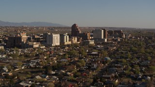 5.7K aerial stock footage of slowly passing by the city's high-rises, seen from neighborhoods, Downtown Albuquerque, New Mexico Aerial Stock Footage | DX0002_122_009