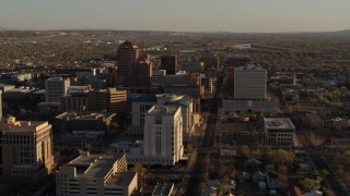 5.7K aerial stock footage of flying by office high-rise buildings behind courthouse in Downtown Albuquerque, New Mexico Aerial Stock Footage | DX0002_122_024