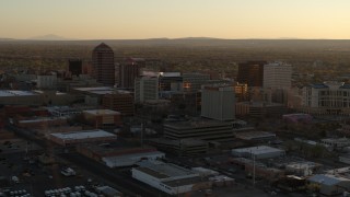 5.7K aerial stock footage of descending past high-rise office buildings at sunset, Downtown Albuquerque, New Mexico Aerial Stock Footage | DX0002_122_035