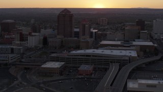 5.7K aerial stock footage orbit office tower and shorter hotel tower behind convention center at sunset, Downtown Albuquerque, New Mexico Aerial Stock Footage | DX0002_122_052