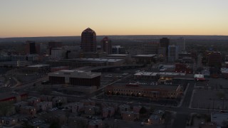 DX0002_123_005 - 5.7K aerial stock footage of office tower and hotel tower at sunset near office high-rises, Downtown Albuquerque, New Mexico