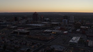 5.7K aerial stock footage ascend and fly away from Albuquerque Plaza and Hyatt Regency at sunset, Downtown Albuquerque, New Mexico Aerial Stock Footage | DX0002_123_010