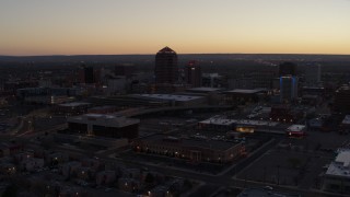 5.7K aerial stock footage passing Albuquerque Plaza and Hyatt Regency at sunset, Downtown Albuquerque, New Mexico Aerial Stock Footage | DX0002_123_015