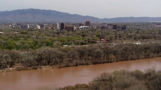 5.7K aerial stock footage of high-rise office buildings seen from the Rio Grande, Downtown Albuquerque, New Mexico Aerial Stock Footage | DX0002_124_001