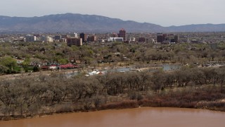 5.7K aerial stock footage wide view of high-rise office buildings, descend beside park, Rio Grande, Downtown Albuquerque, New Mexico Aerial Stock Footage | DX0002_124_004