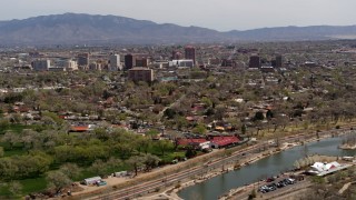 5.7K aerial stock footage flying by high-rise office buildings seen from Tingley Beach, Downtown Albuquerque, New Mexico Aerial Stock Footage | DX0002_124_006