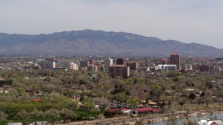 5.7K aerial stock footage descend with wide view of high-rise office buildings, distant mountains, Downtown Albuquerque, New Mexico Aerial Stock Footage | DX0002_124_018