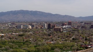 5.7K aerial stock footage descend with wide view of high-rise office buildings, distant mountains, Downtown Albuquerque, New Mexico Aerial Stock Footage | DX0002_124_019