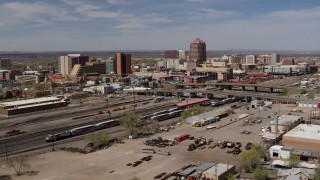 5.7K aerial stock footage passing railroad tracks with view of Albuquerque Plaza and surrounding buildings, Downtown Albuquerque, New Mexico Aerial Stock Footage | DX0002_124_029