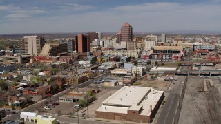 5.7K aerial stock footage flyby train tracks, focus on Albuquerque Plaza and surrounding buildings, Downtown Albuquerque, New Mexico Aerial Stock Footage | DX0002_124_030