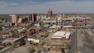 5.7K aerial stock footage reverse view of office buildings, and flyby railroad tracks, Downtown Albuquerque, New Mexico Aerial Stock Footage | DX0002_124_036