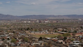 5.7K aerial stock footage flying by suburban homes with a view of Downtown Albuquerque in the distance, New Mexico Aerial Stock Footage | DX0002_126_001