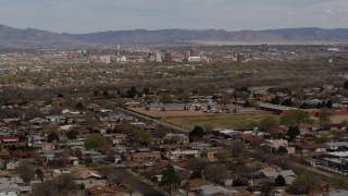 5.7K aerial stock footage passing by a suburban neighborhood with Downtown Albuquerque in the distance, New Mexico Aerial Stock Footage | DX0002_126_006