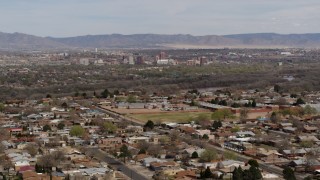 5.7K aerial stock footage fly away from Downtown Albuquerque and Rio Grande, seen from suburban homes, New Mexico Aerial Stock Footage | DX0002_126_010