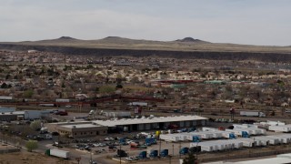 5.7K aerial stock footage of suburban neighborhood across freeway, descend near warehouse building in Albuquerque, New Mexico Aerial Stock Footage | DX0002_126_015