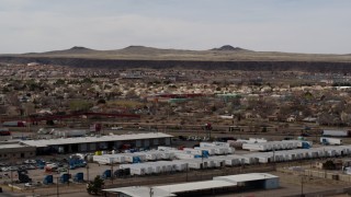 5.7K aerial stock footage of passing a suburban neighborhood across freeway, Albuquerque, New Mexico Aerial Stock Footage | DX0002_126_016