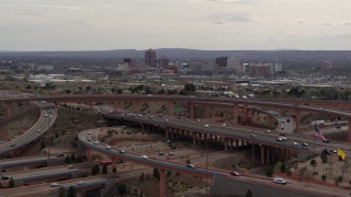 5.7K aerial stock footage of Downtown Albuquerque seen while passing by freeway interchange, New Mexico Aerial Stock Footage | DX0002_126_022