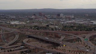 5.7K aerial stock footage of Downtown Albuquerque buildings seen while passing freeway interchange traffic, New Mexico Aerial Stock Footage | DX0002_126_030