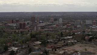 5.7K aerial stock footage reverse view of city's high-rise buildings seen from neighborhood, Downtown Albuquerque, New Mexico Aerial Stock Footage | DX0002_126_037