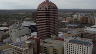 5.7K aerial stock footage flying away from Albuquerque Plaza and neighboring city buildings, Downtown Albuquerque, New Mexico Aerial Stock Footage | DX0002_127_005