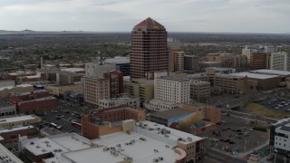 DX0002_127_008 - 5.7K aerial stock footage wide orbit of Albuquerque Plaza high-rise and neighboring city buildings, Downtown Albuquerque, New Mexico