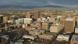 5.7K aerial stock footage of flying by Albuquerque Plaza towering over city buildings, Downtown Albuquerque, New Mexico Aerial Stock Footage | DX0002_127_028