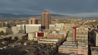 5.7K aerial stock footage wide orbit of Albuquerque Plaza high-rise towering over city buildings, Downtown Albuquerque, New Mexico Aerial Stock Footage | DX0002_127_031