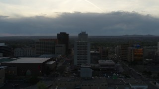 DX0002_128_012 - 5.7K aerial stock footage flyby Kiva Auditorium to approach hotel at sunset, Downtown Albuquerque, New Mexico