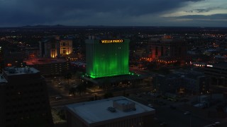 DX0002_128_025 - 5.7K aerial stock footage of flying by the Wells Fargo Building at twilight, Downtown Albuquerque, New Mexico