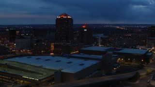 5.7K aerial stock footage fly away from office high-rise, hotel, auditorium and reveal convention center at twilight, Downtown Albuquerque, New Mexico Aerial Stock Footage | DX0002_128_032