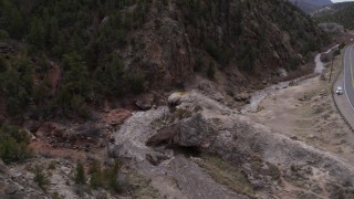 5.7K aerial stock footage ascend and fly away from river rapids flowing through a rock formation in the mountains in New Mexico Aerial Stock Footage | DX0002_129_005