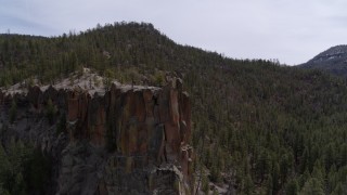 5.7K aerial stock footage of orbiting a rock formation in the mountains in New Mexico Aerial Stock Footage | DX0002_129_010