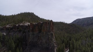 5.7K aerial stock footage approach and fly over a rock formation jutting from a mountain in New Mexico Aerial Stock Footage | DX0002_129_014