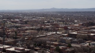 5.7K aerial stock footage flying by Radio Plaza for a view of the city's downtown area, Santa Fe, New Mexico Aerial Stock Footage | DX0002_129_031