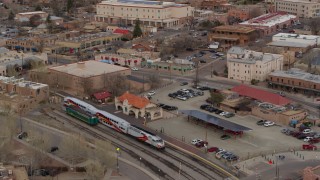 5.7K aerial stock footage approach and tilt to a passenger train at a station in Santa Fe, New Mexico, tilt to top of the train Aerial Stock Footage | DX0002_130_023