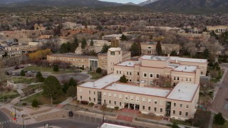 DX0002_131_007 - 5.7K aerial stock footage orbit and fly away from the Bataan Memorial Building, Santa Fe, New Mexico