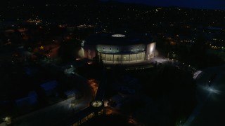 DX0002_132_023 - 5.7K aerial stock footage of slowly orbiting the New Mexico State Capitol at night, Santa Fe, New Mexico