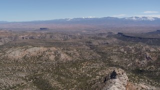 5.7K aerial stock footage of flying away from desert mesas and distant mountains in New Mexico Aerial Stock Footage | DX0002_133_014