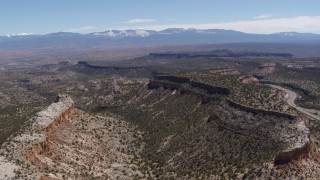 5.7K aerial stock footage reverse view of flat desert mesas and distant mountains in New Mexico Aerial Stock Footage | DX0002_133_015