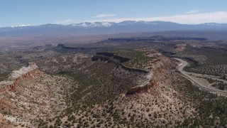 5.7K aerial stock footage of flying away from flat desert mesas and distant mountains in New Mexico Aerial Stock Footage | DX0002_133_016