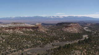 5.7K aerial stock footage of a view of flat desert mesas and mountains in the background in New Mexico Aerial Stock Footage | DX0002_133_018