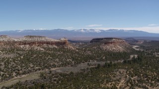 5.7K aerial stock footage fly away from and past flat desert mesas and distant mountains in New Mexico Aerial Stock Footage | DX0002_133_021