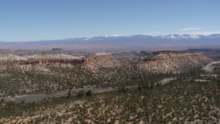 5.7K aerial stock footage fly away from flat desert mesas and distant mountains, New Mexico Aerial Stock Footage | DX0002_133_022