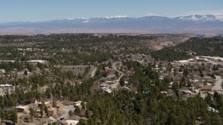 DX0002_134_013 - 5.7K aerial stock footage of homes and mesas with a view of mountains in Los Alamos, New Mexico