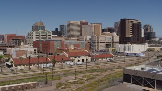 5.7K aerial stock footage of flying near a train station and focus on skyline of Downtown Phoenix, Arizona Aerial Stock Footage | DX0002_136_018