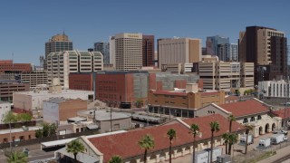 5.7K aerial stock footage of a reverse view of a train station and city skyline of Downtown Phoenix, Arizona Aerial Stock Footage | DX0002_136_020