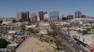 5.7K aerial stock footage of a reverse view of tall office buildings seen from city streets, Downtown Phoenix, Arizona Aerial Stock Footage | DX0002_136_029